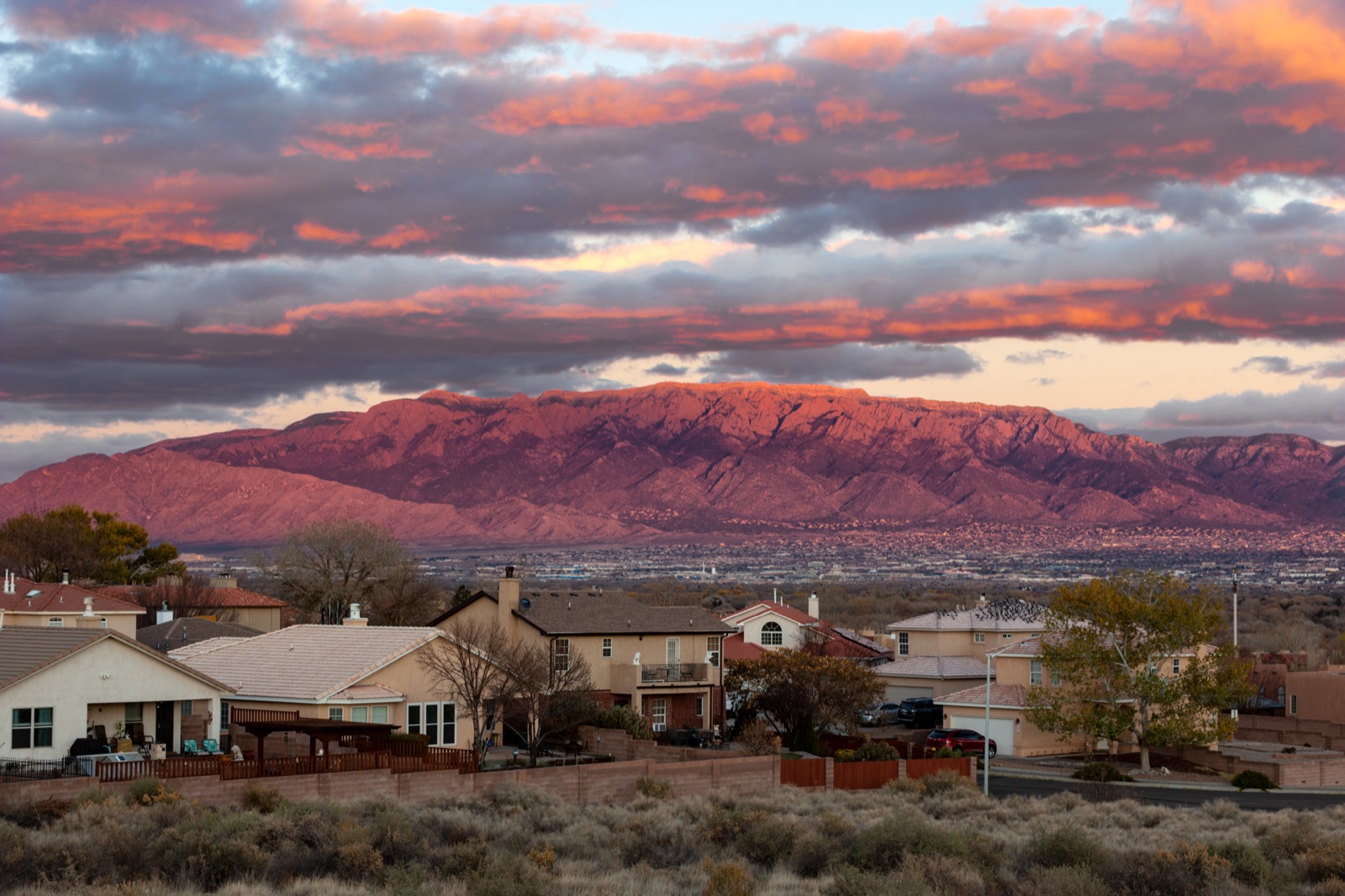 Pink-clouded sunset over distant mountains